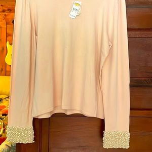 Light pink long sleeve mostly silk sweater w delicate white pearl cuffs. Size L